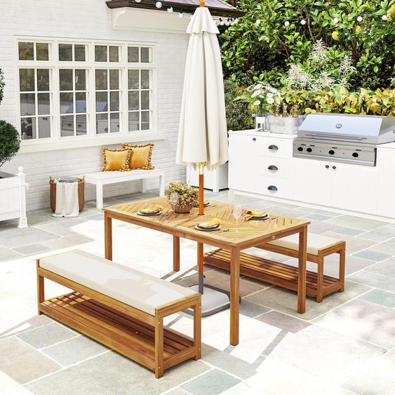 Ensemble de jardin en bois dacacia composé dune table et de deux bancs, avec trou pour parasol, coussins, dimensions : 150x85x75 cm. Bois : teck